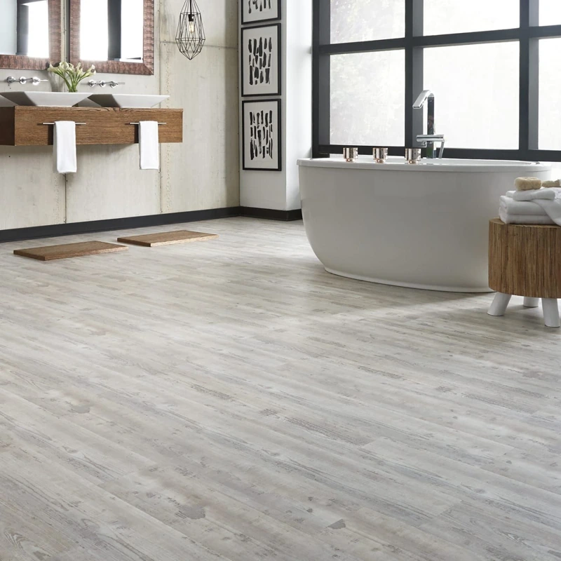 Distressed white wood flooring in modern bathroom