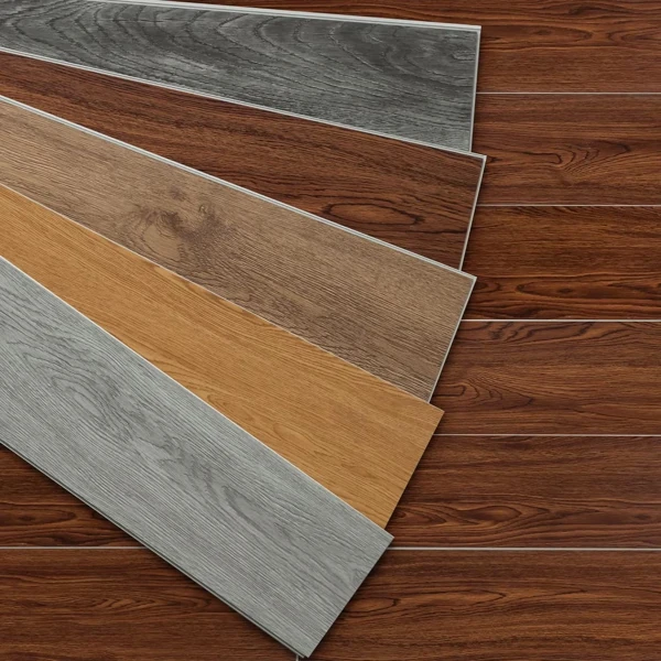 Fanned wood flooring samples in various shades and grains.