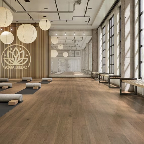 Modern industrial yoga studio with wood floors and mats.