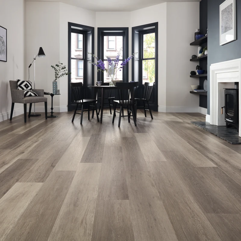 Multi-tonal grey wood flooring in spacious dining area